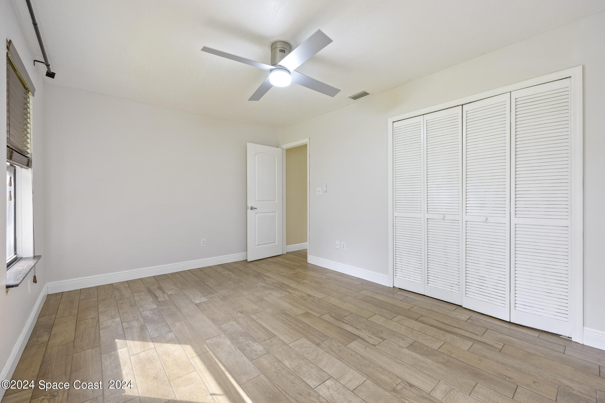 3725 Laurette Road Merritt Island, FL 32952 - Photo 31 of 46 wooden floor in an empty room with a window