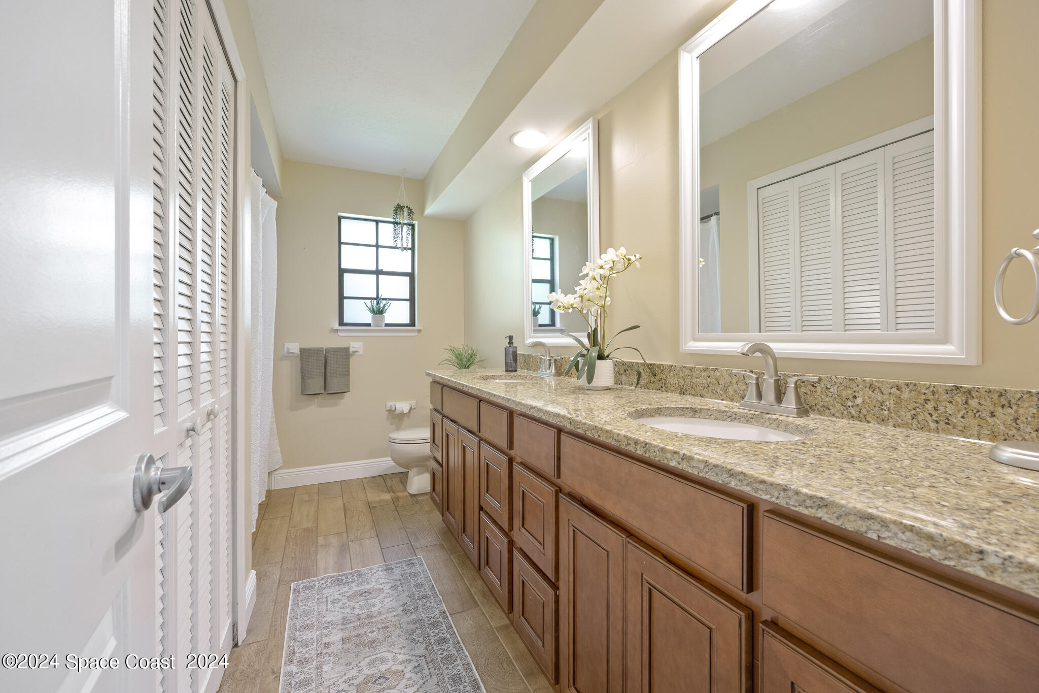 3725 Laurette Road Merritt Island, FL 32952 - Photo 32 of 46 a bathroom with a granite countertop sink mirror and a bathtub