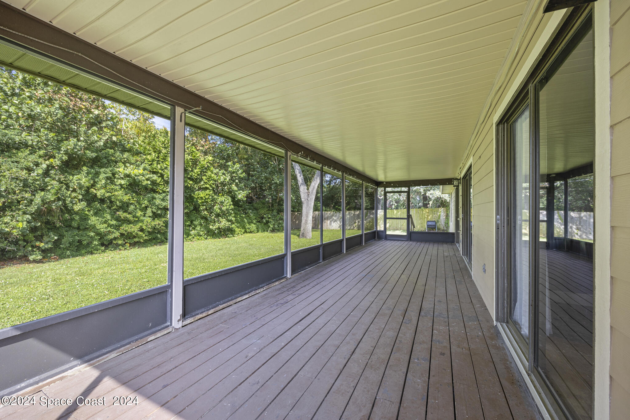 3725 Laurette Road Merritt Island, FL 32952 - Photo 35 of 46 a view of hallway with a large window and wooden floor