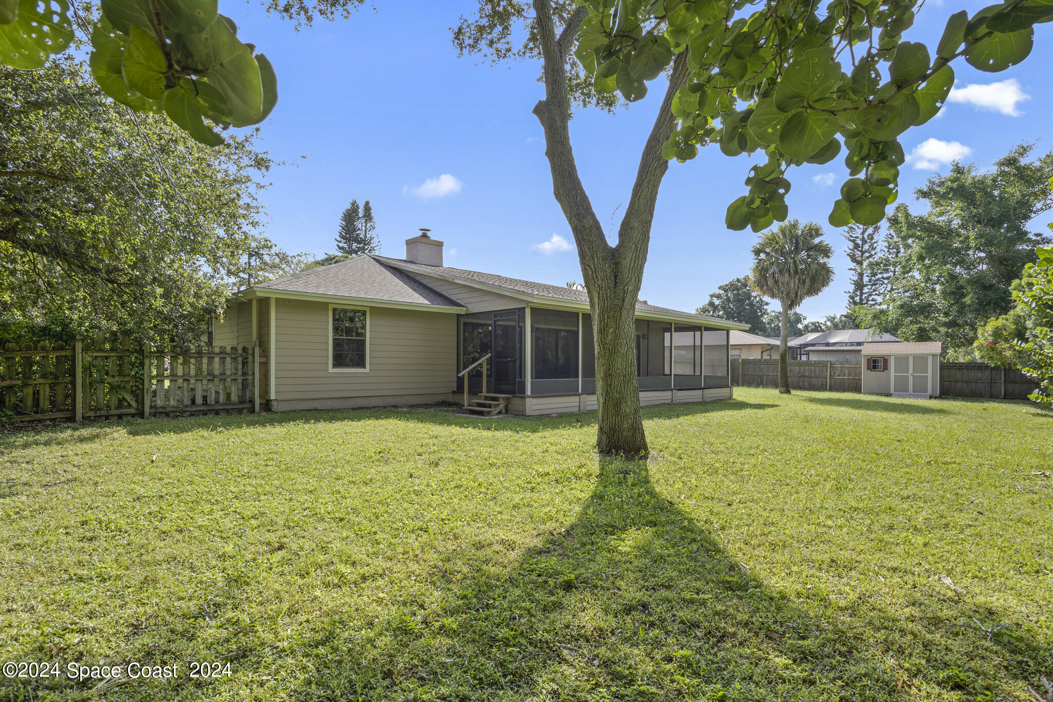 3725 Laurette Road Merritt Island, FL 32952 - Photo 36 of 46 a yellow house with garden in front of it