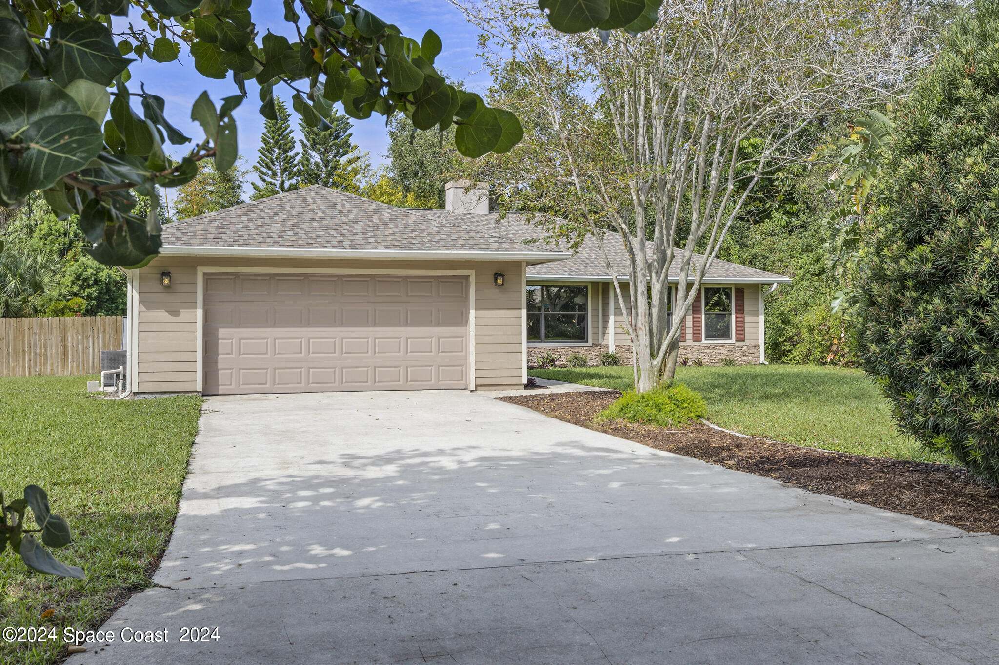3725 Laurette Road Merritt Island, FL 32952 - Photo 41 of 46 a front view of a house with a yard and garage