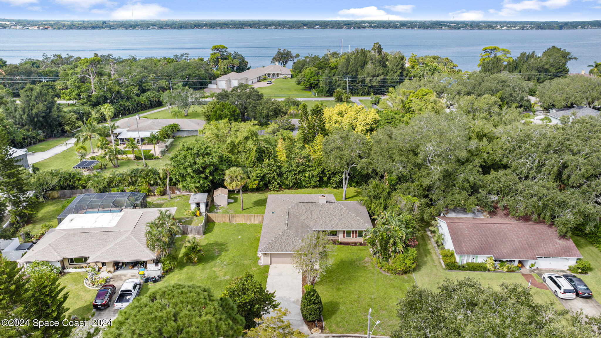 3725 Laurette Road Merritt Island, FL 32952 - Photo 42 of 46 an aerial view of a house with a garden and lake view