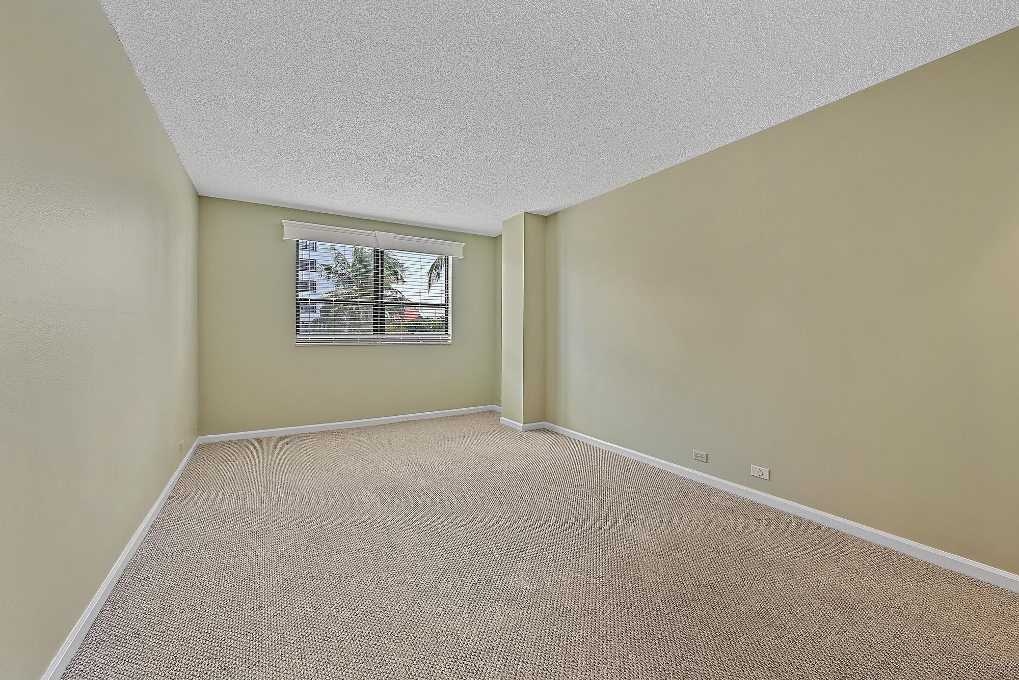 1208 Marine Way, Unit 105 North Palm Beach, FL 33408 - Photo 13 of 22 an empty room with windows