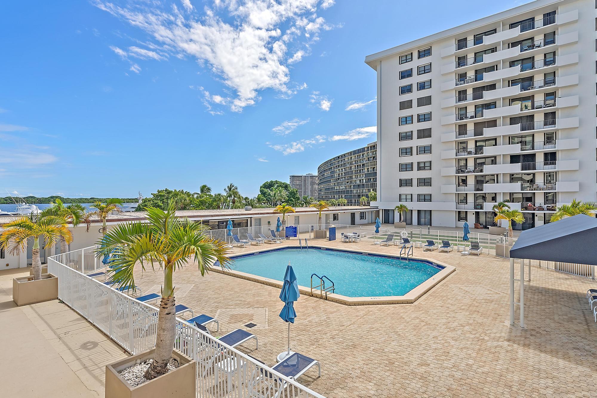1208 Marine Way, Unit 105 North Palm Beach, FL 33408 - Photo 8 of 22 a view of a swimming pool with a lounge chair