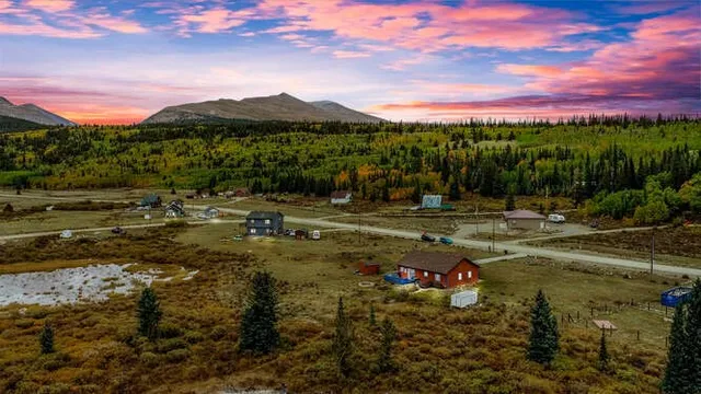a view of a town with mountains & around