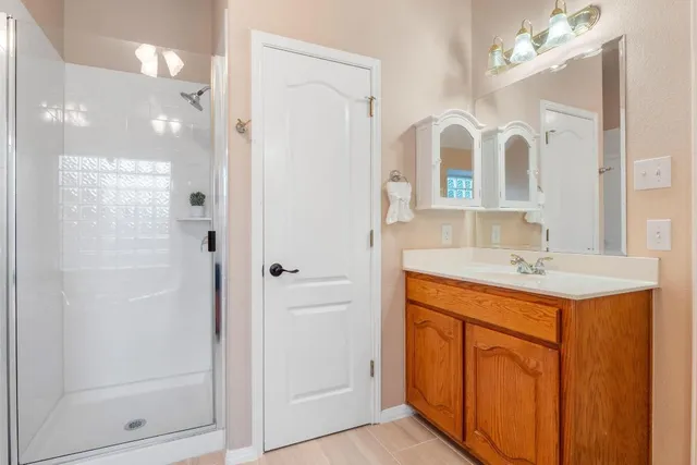 a bathroom with double vanity sink and mirror