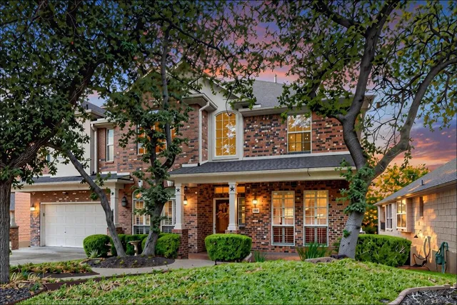 front view of a house with a tree