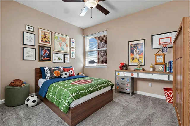 a bedroom with a bed and a desk