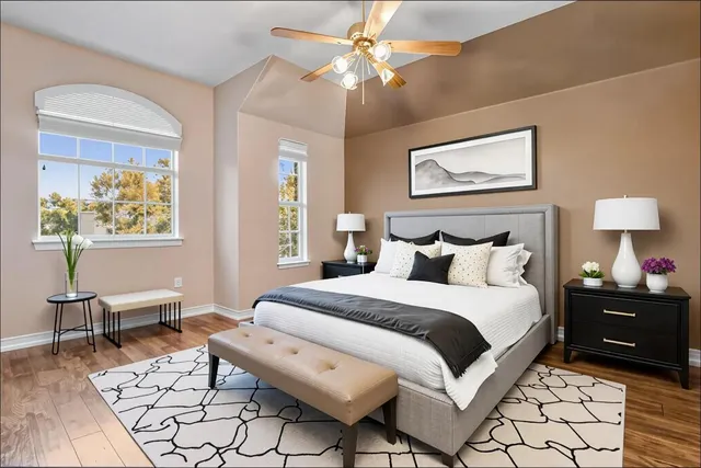 a bedroom with bed and wooden floor