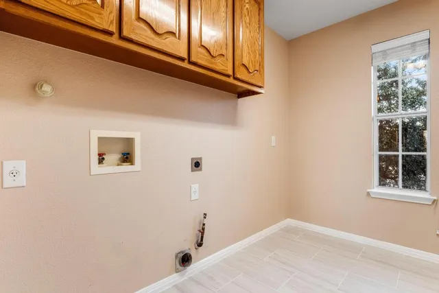 a view of a closet area with wooden floor