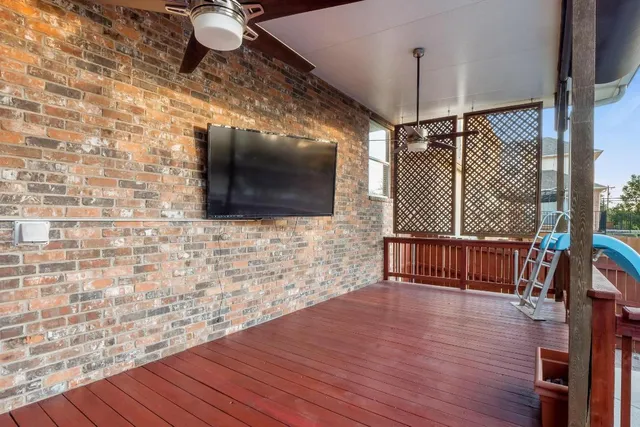 a living room with couch wooden floor and a flat screen tv