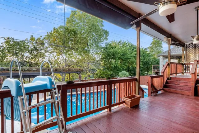 a view of a deck with couches next to a yard