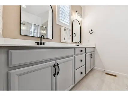 a bathroom with a double vanity sink and mirror