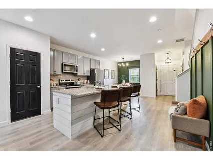 a kitchen with cabinets and refrigerator