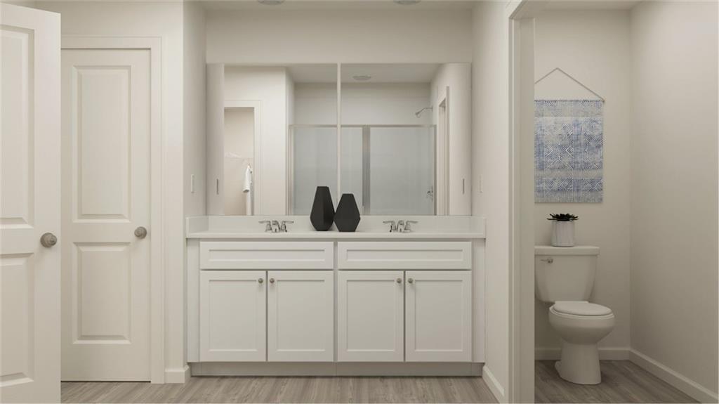 517 Almere Drive Hampton, GA 30228 - Photo 29 of 41 a bathroom with a toilet a sink and mirror