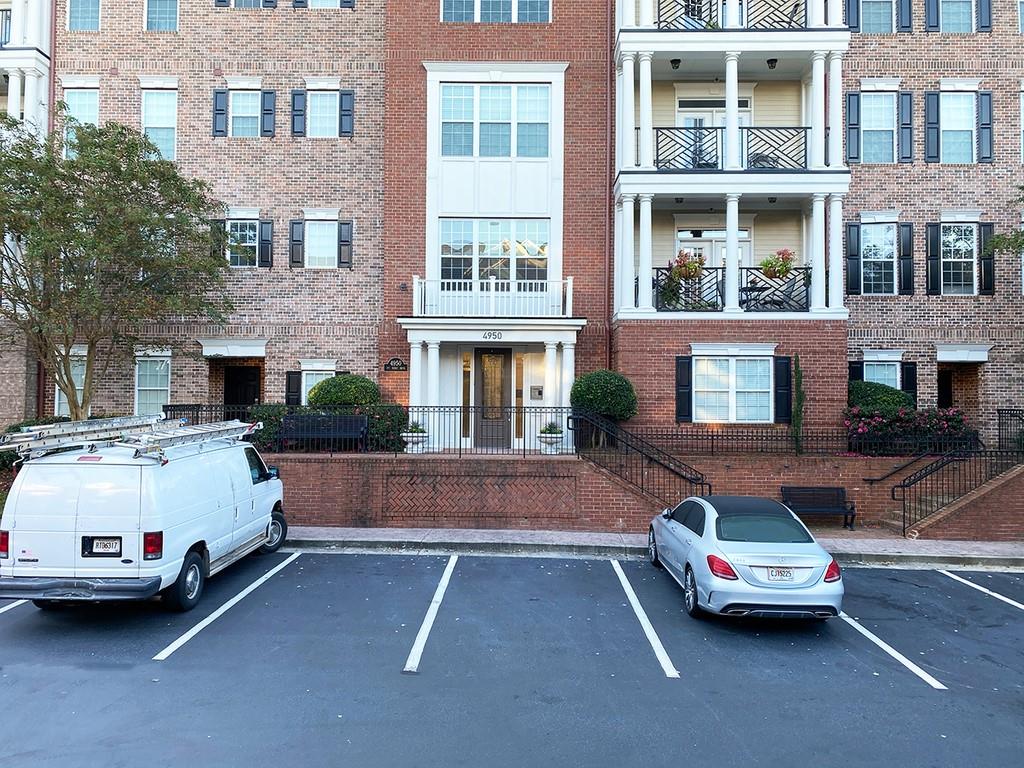 a view of a car parked in front of a brick building