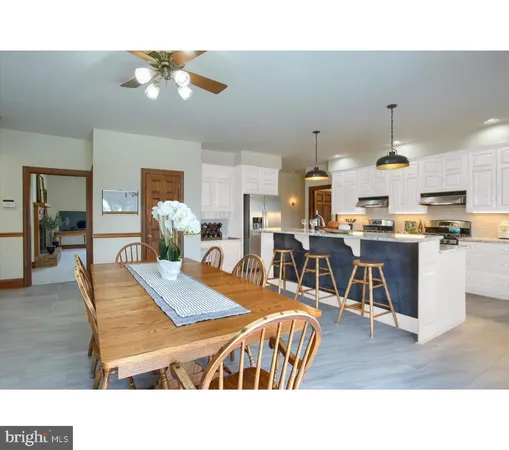a kitchen with stainless steel appliances granite countertop a stove and a white cabinets