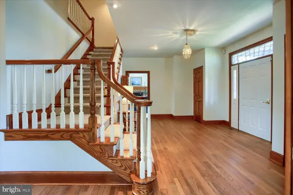 an empty room with windows and fireplace