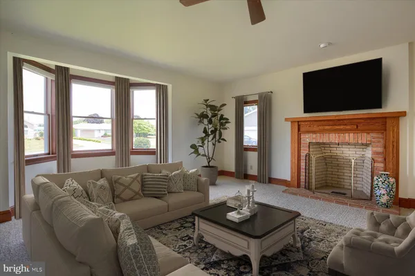 a view of a livingroom with a fireplace and window
