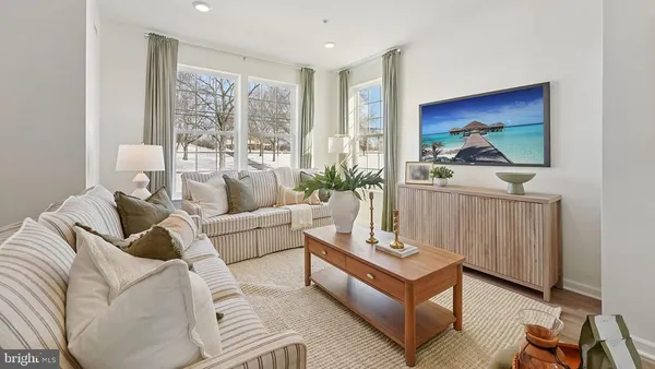 a living room with furniture a large window with outer view