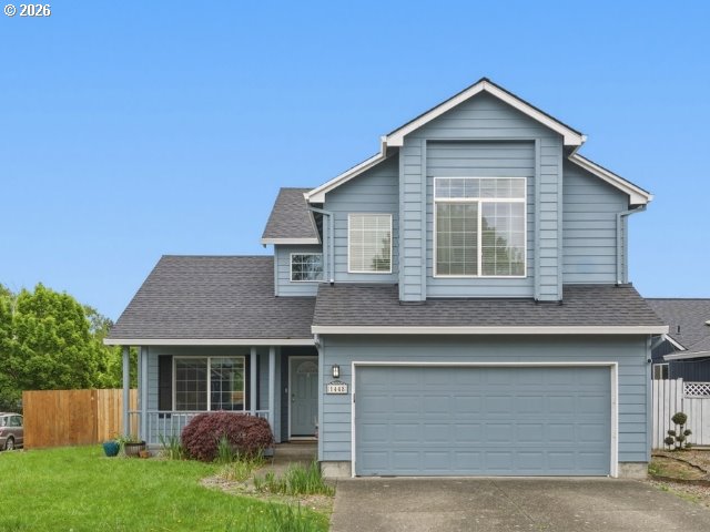 1448 Southwest 208th Avenue Beaverton, OR 97003 - Photo 1 of 39 a front view of a house with a yard and garage