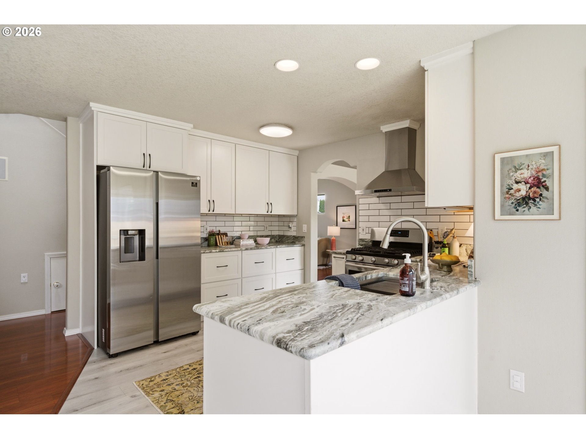 1448 Southwest 208th Avenue Beaverton, OR 97003 - Photo 11 of 39 a kitchen with stainless steel appliances granite countertop a refrigerator a stove a sink a oven and a refrigerator
