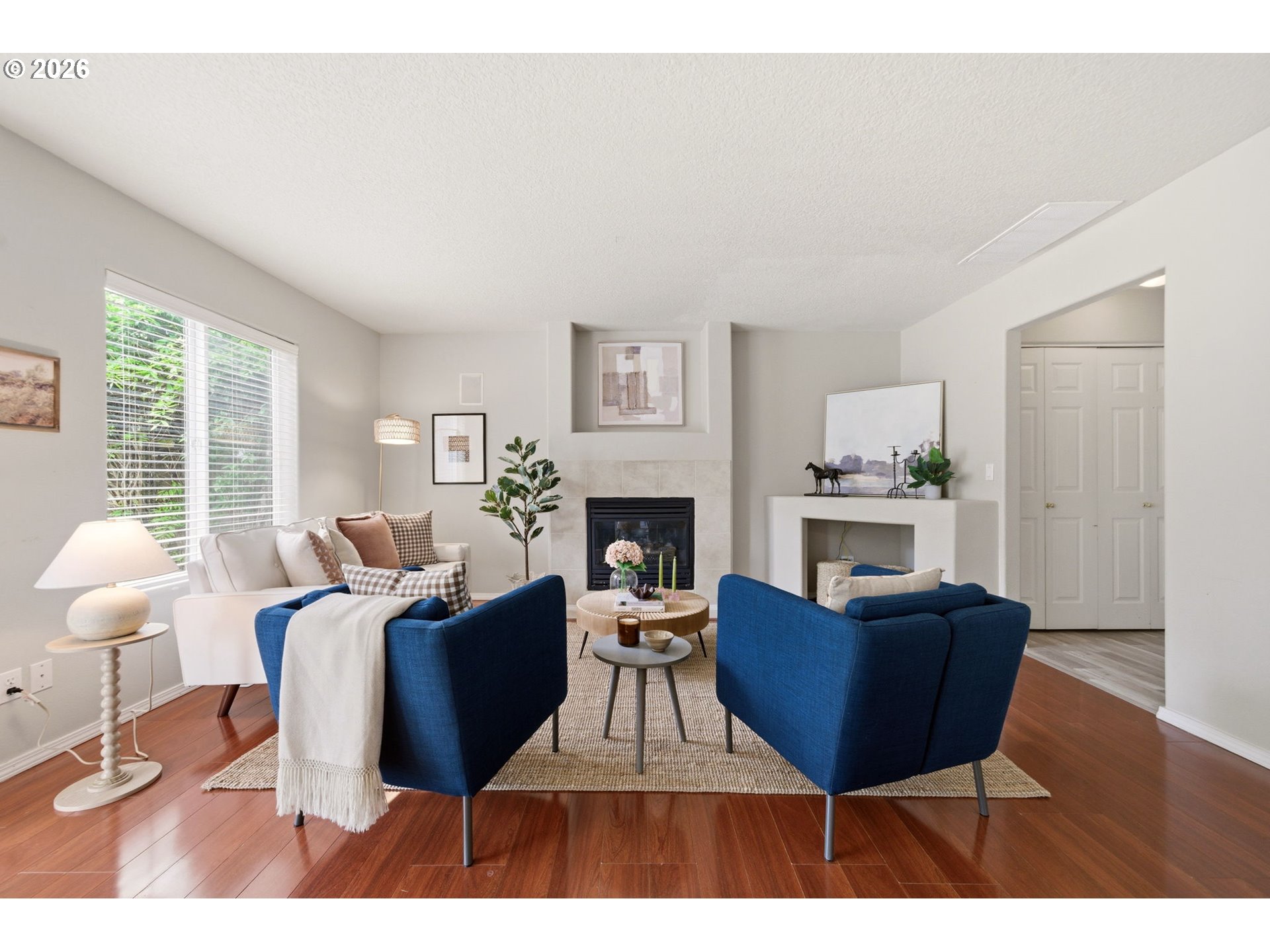 1448 Southwest 208th Avenue Beaverton, OR 97003 - Photo 18 of 39 a living room with furniture a fireplace and a table