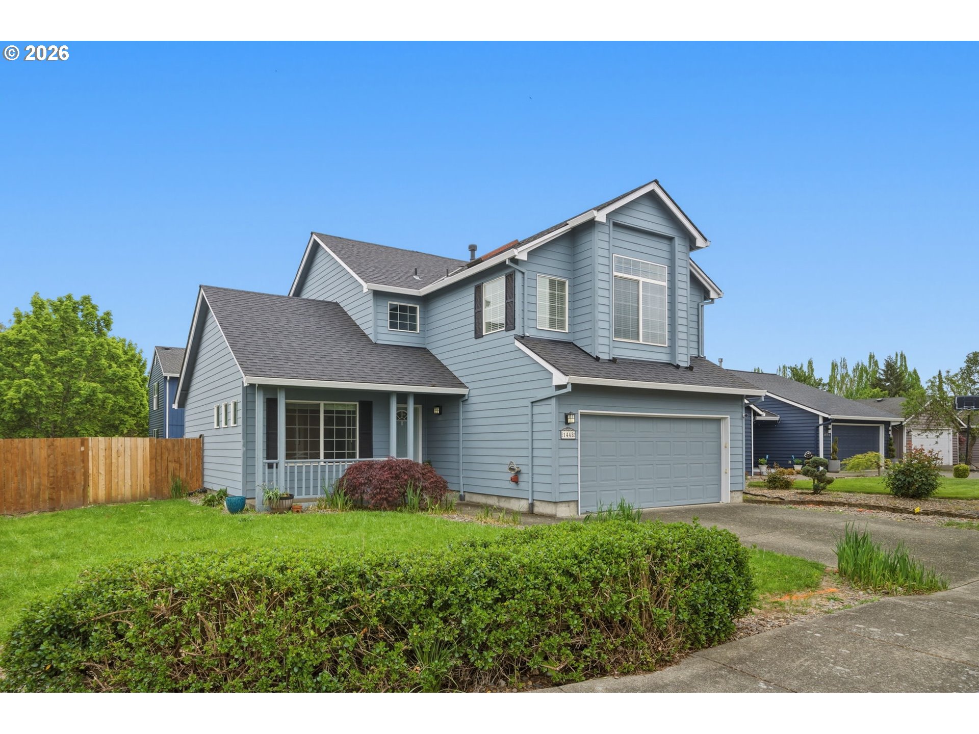1448 Southwest 208th Avenue Beaverton, OR 97003 - Photo 2 of 39 a front view of a house with a yard and garage