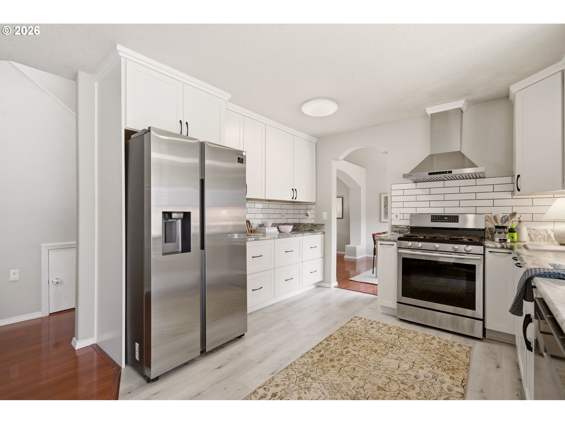 1448 Southwest 208th Avenue Beaverton, OR 97003 - Photo 10 of 39 a kitchen with stainless steel appliances a stove a sink and a refrigerator
