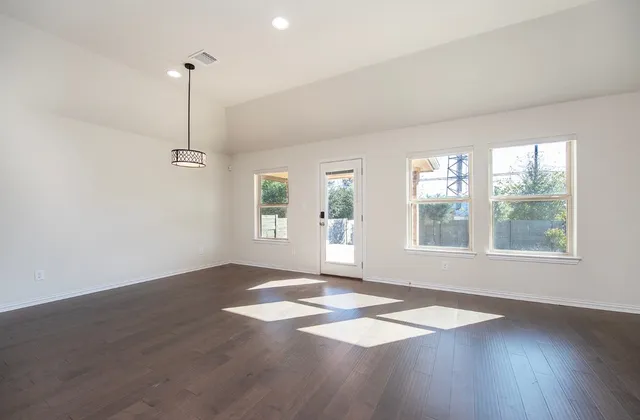 a view of kitchen with microwave a stove and wooden floor