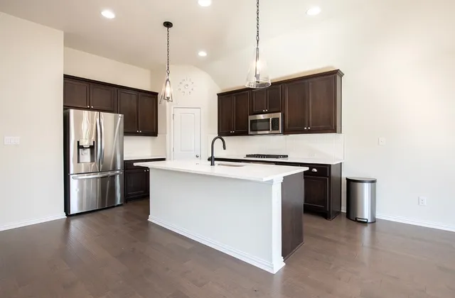a kitchen with a sink stove and refrigerator