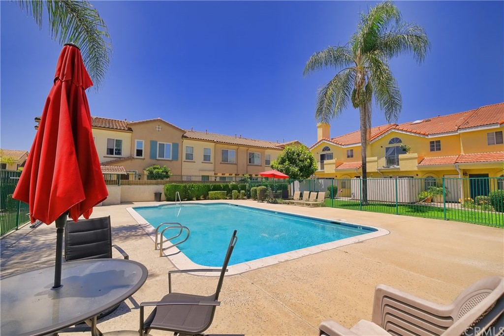 11445 Excelsior Drive Norwalk, CA 90650 - Photo 14 of 18 a view of a swimming pool with a table and chairs