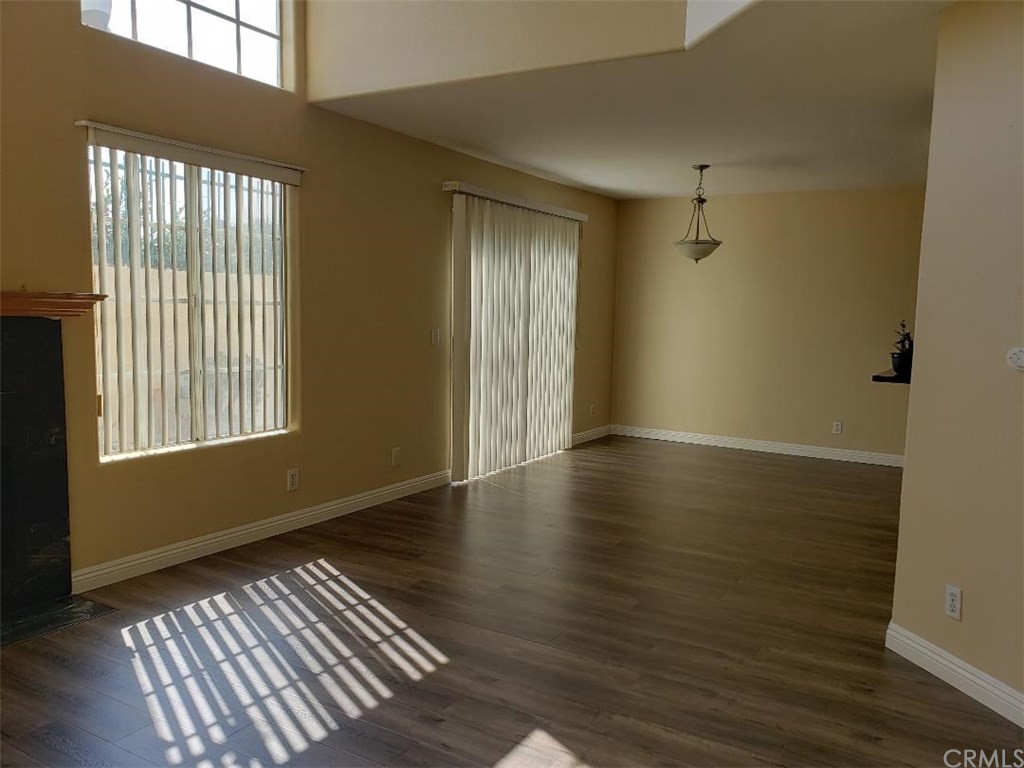 11445 Excelsior Drive Norwalk, CA 90650 - Photo 4 of 18 a view of an empty room with wooden floor and a window