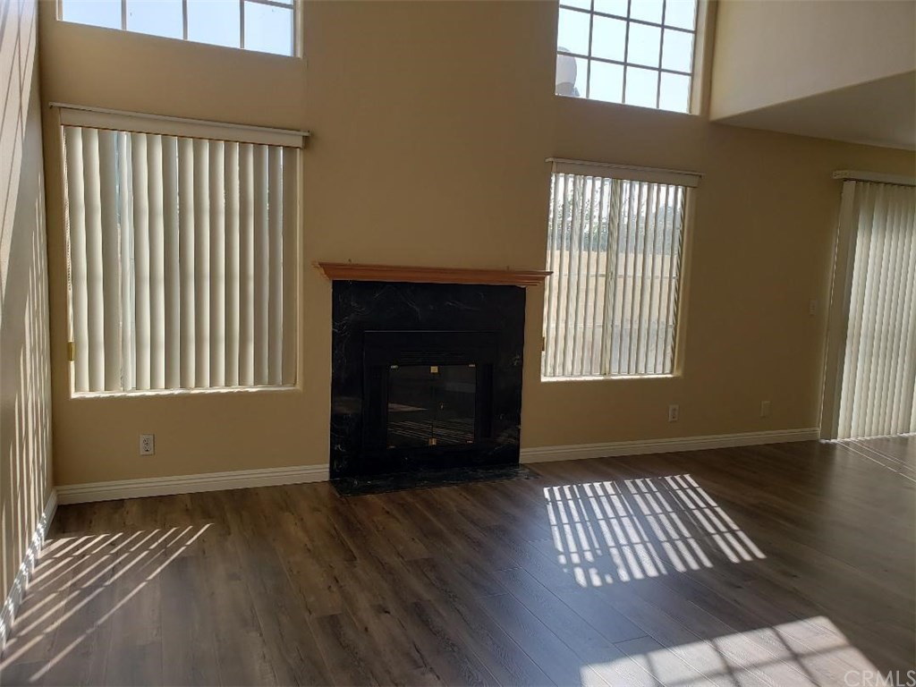 11445 Excelsior Drive Norwalk, CA 90650 - Photo 5 of 18 an empty room with wooden floor and windows