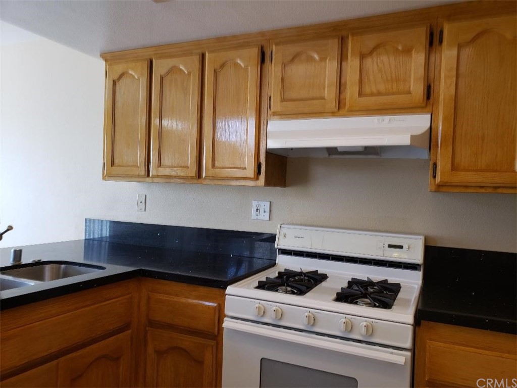11445 Excelsior Drive Norwalk, CA 90650 - Photo 8 of 18 a kitchen with stainless steel appliances granite countertop a stove and a microwave
