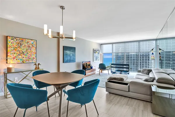 a living room with furniture and a chandelier