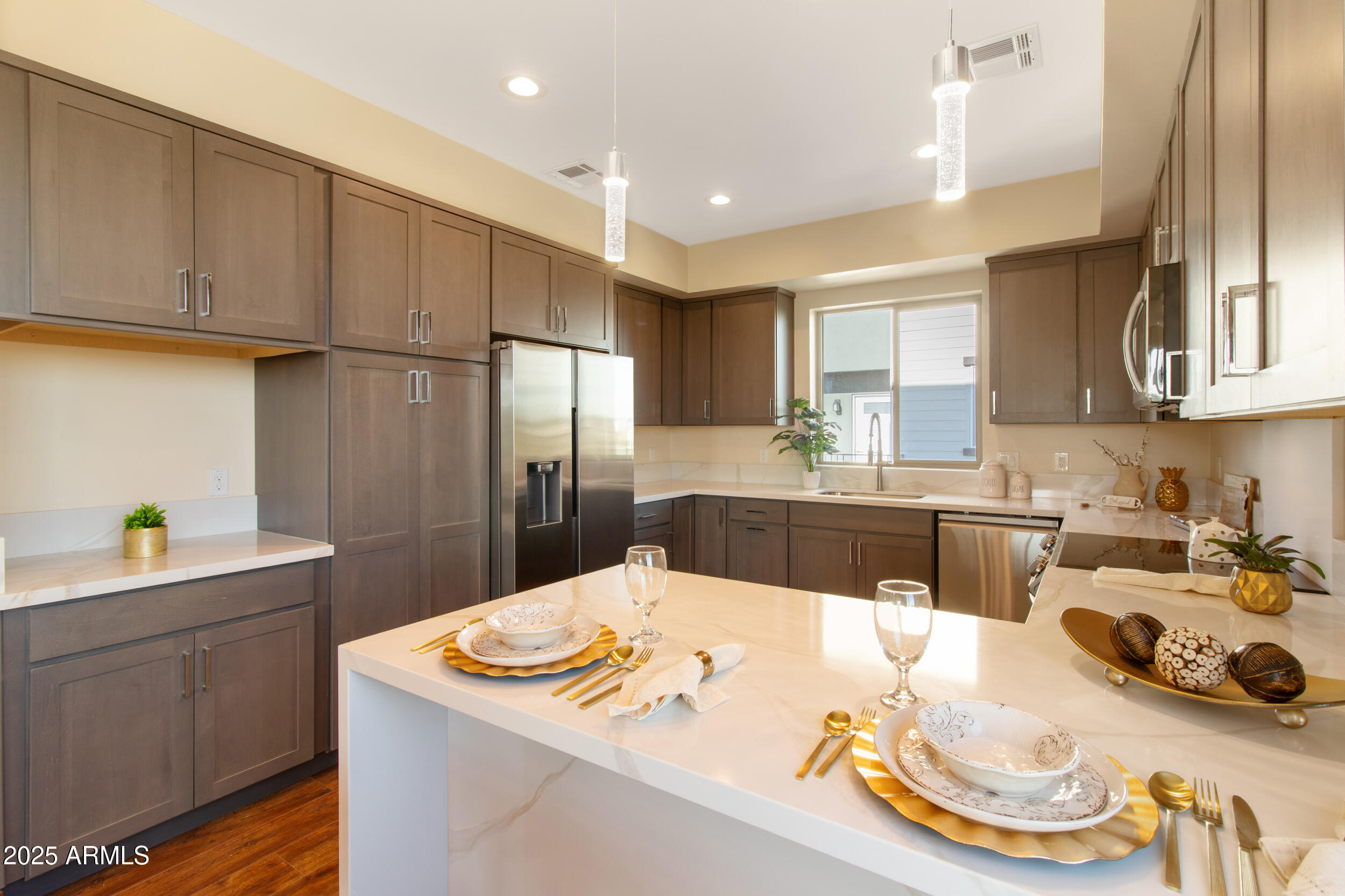 2014 West Lawrence Road Phoenix, AZ 85015 - Photo 12 of 24 a kitchen with stainless steel appliances kitchen island granite countertop a sink a refrigerator and a stove
