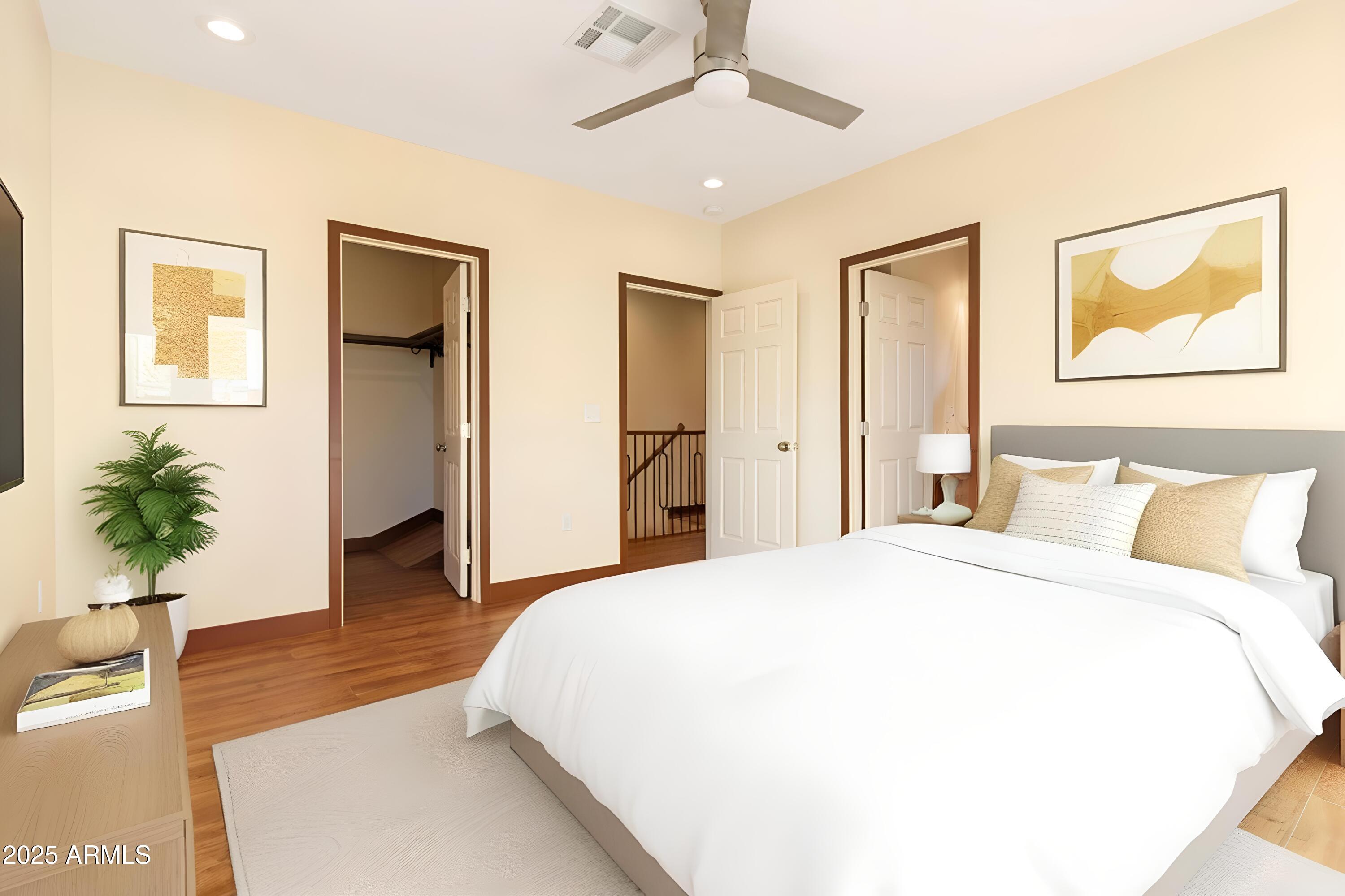2014 West Lawrence Road Phoenix, AZ 85015 - Photo 17 of 24 a spacious bedroom with a bed and a potted plant