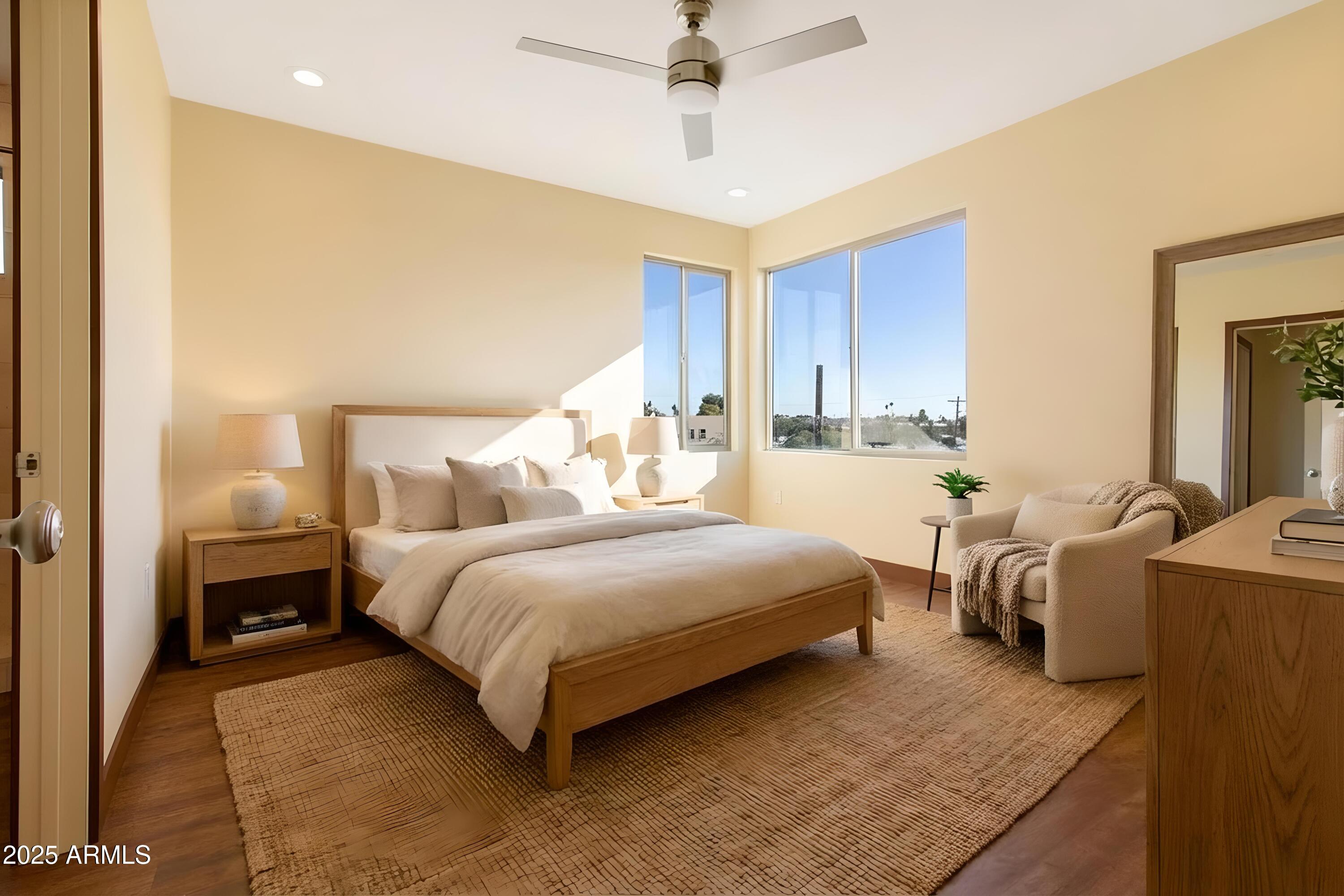 2014 West Lawrence Road Phoenix, AZ 85015 - Photo 22 of 24 a bedroom with bed and a chandelier