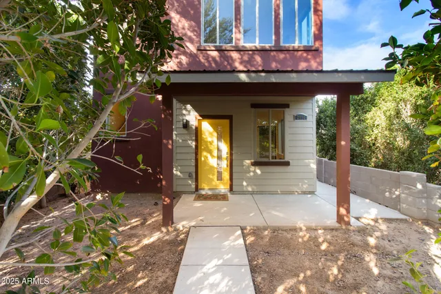 a bathroom with a granite countertop toilet a sink and a mirror