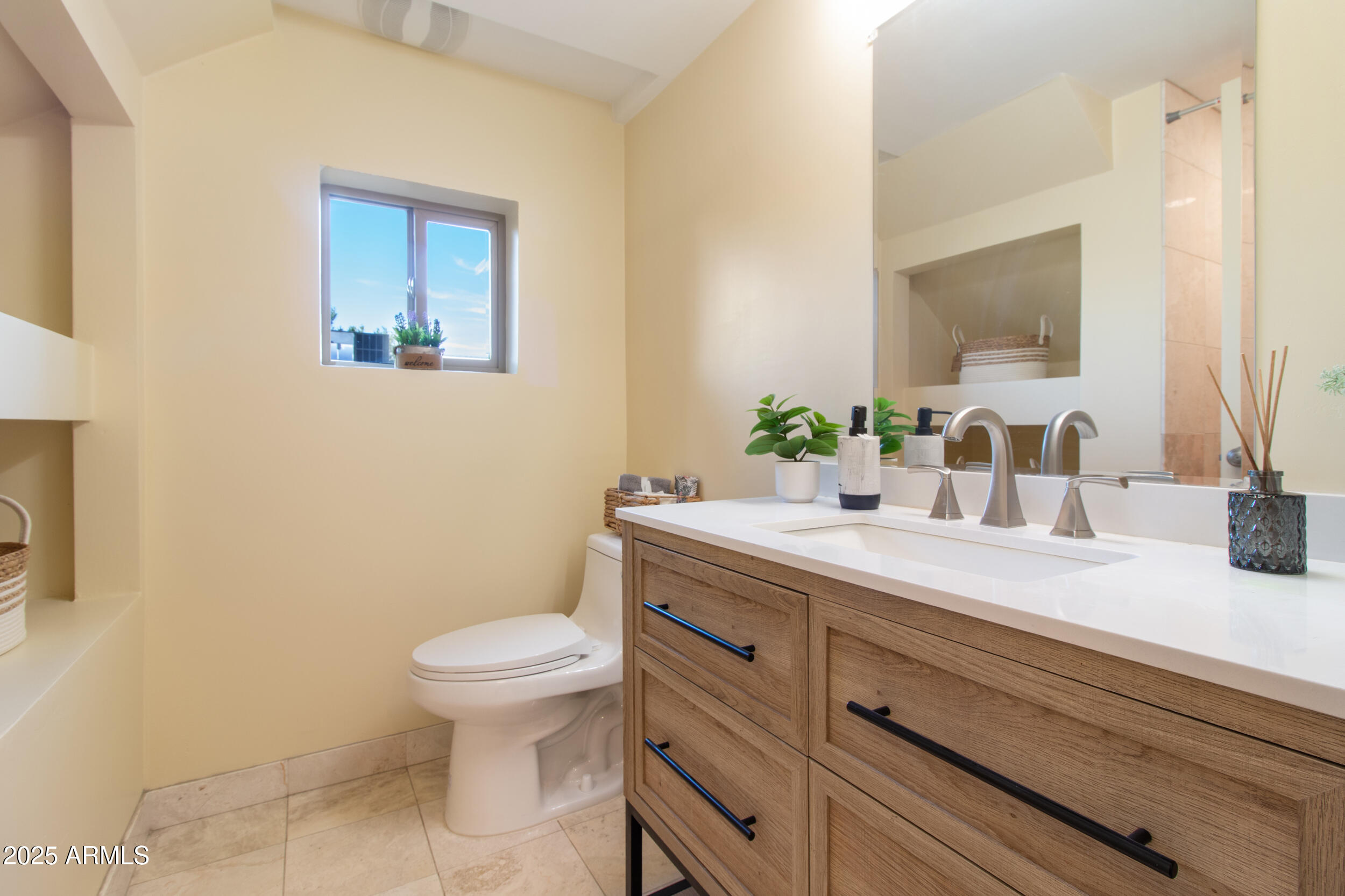 2014 West Lawrence Road Phoenix, AZ 85015 - Photo 7 of 24 a bathroom with a granite countertop toilet a sink and a mirror