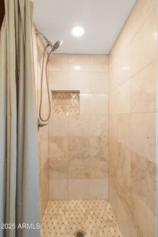 a kitchen with stainless steel appliances kitchen island granite countertop a sink a refrigerator and a stove