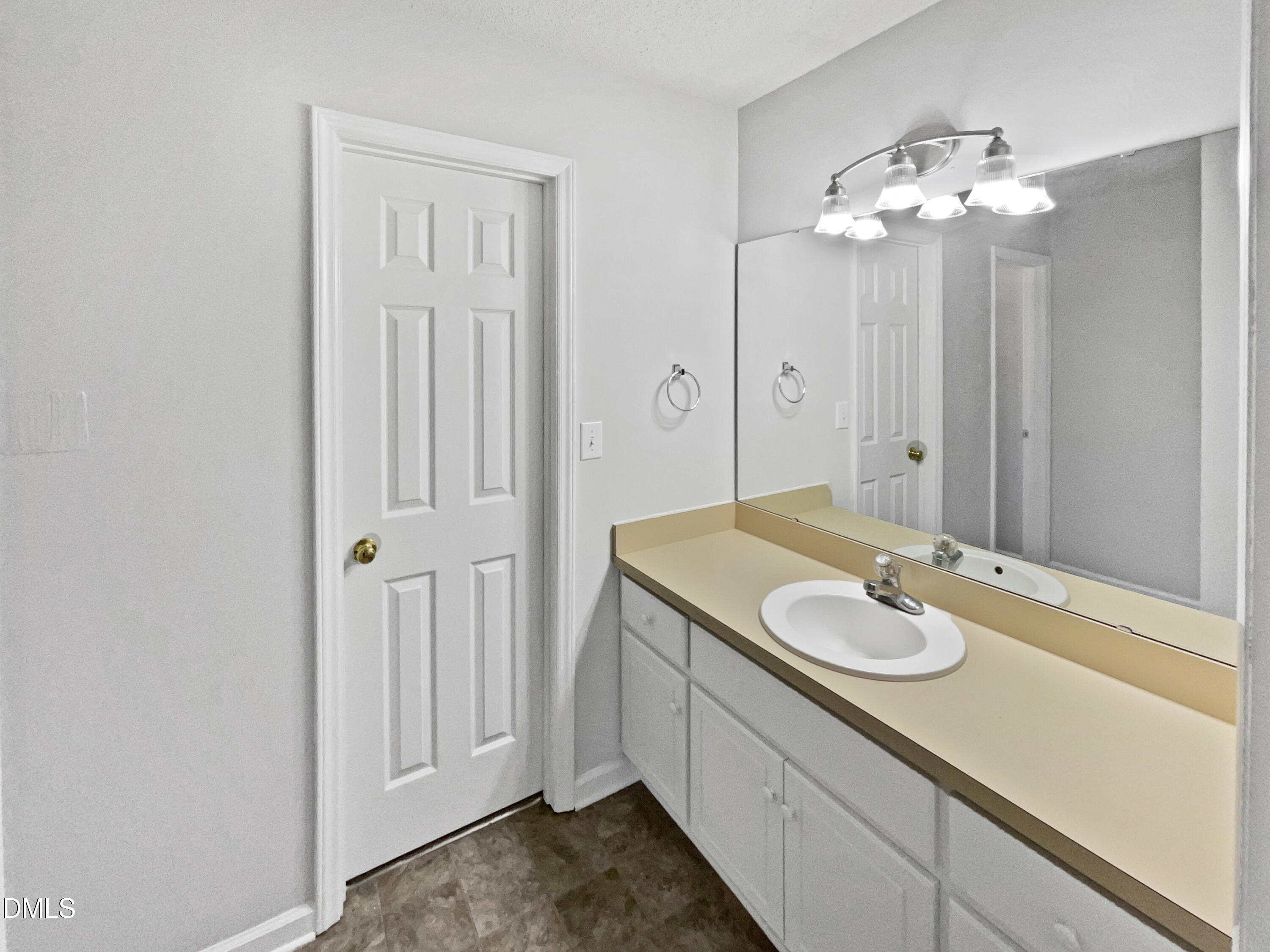 9025 Ferrell Road Zebulon, NC 27597 - Photo 14 of 19 a bathroom with a sink a vanity and a mirror