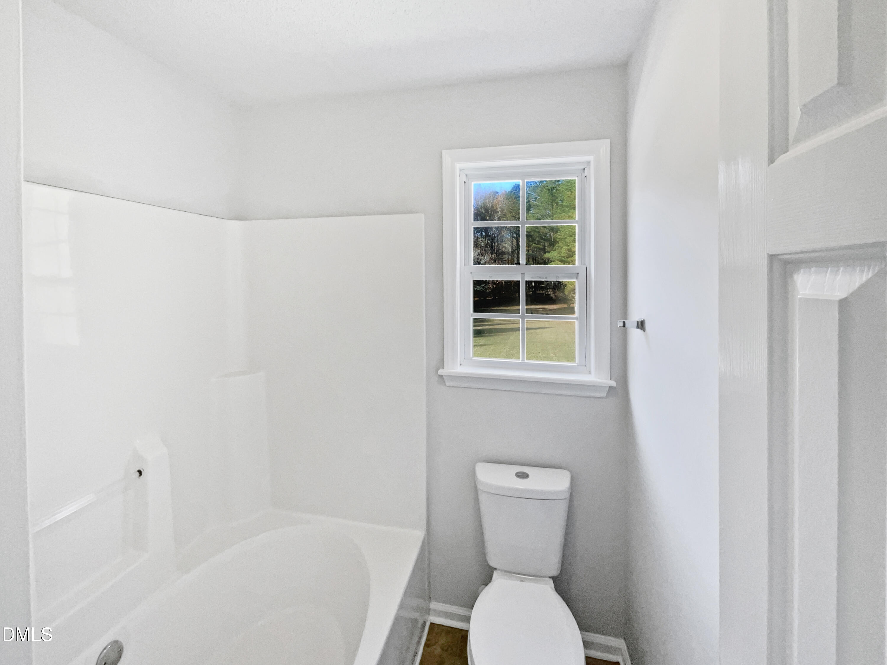 9025 Ferrell Road Zebulon, NC 27597 - Photo 15 of 19 a bathroom with a toilet and a bathtub