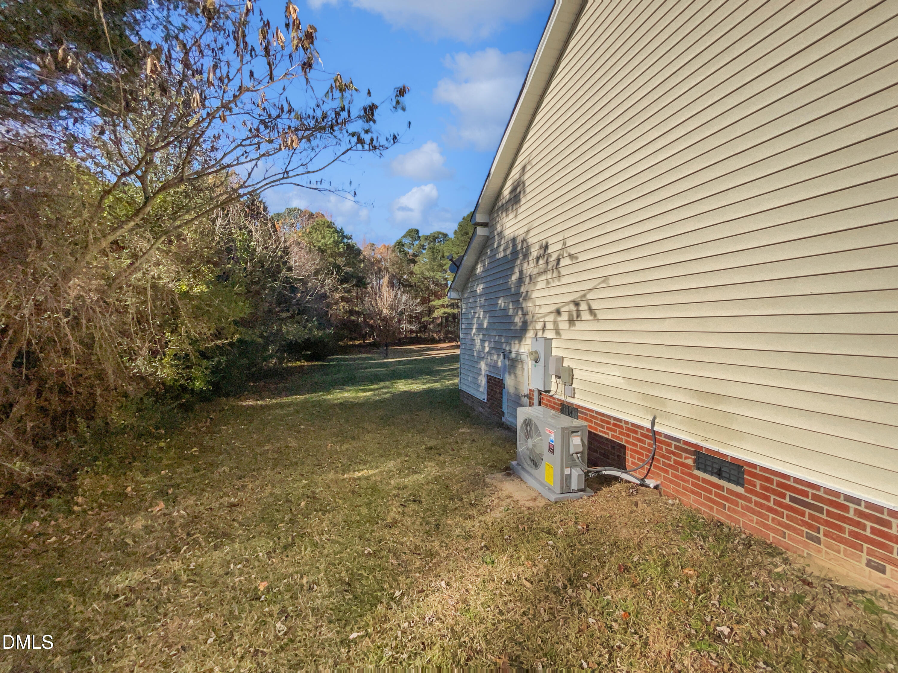 9025 Ferrell Road Zebulon, NC 27597 - Photo 17 of 19 a view of a small house with a yard