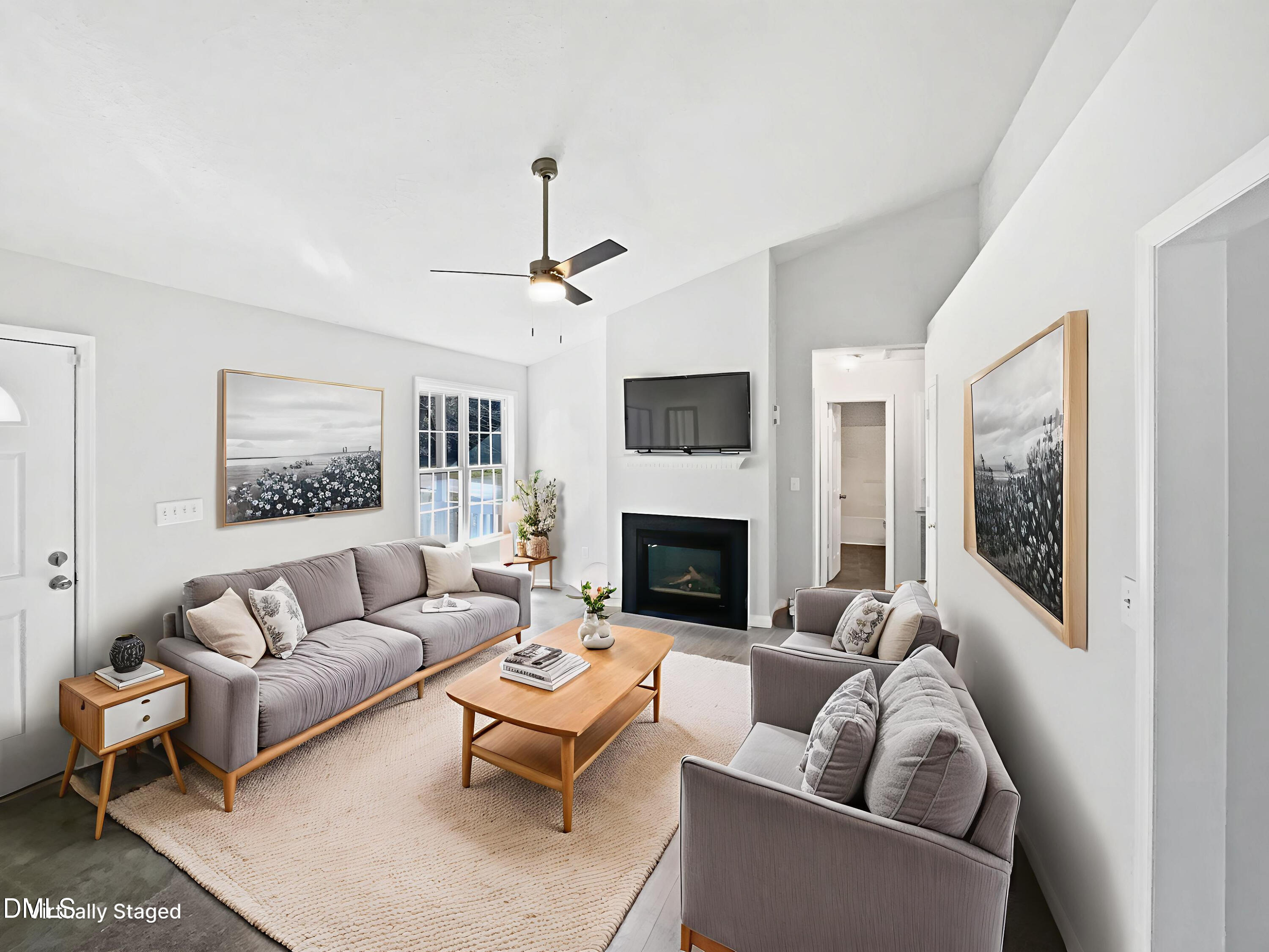 9025 Ferrell Road Zebulon, NC 27597 - Photo 2 of 19 a living room with furniture and a fireplace