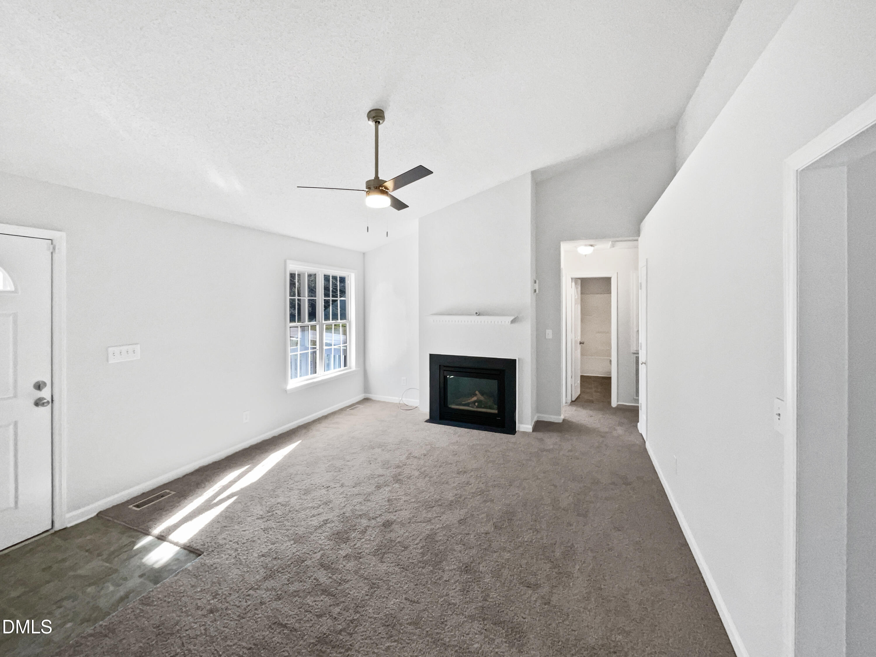 9025 Ferrell Road Zebulon, NC 27597 - Photo 3 of 19 a view of an empty room with a fireplace