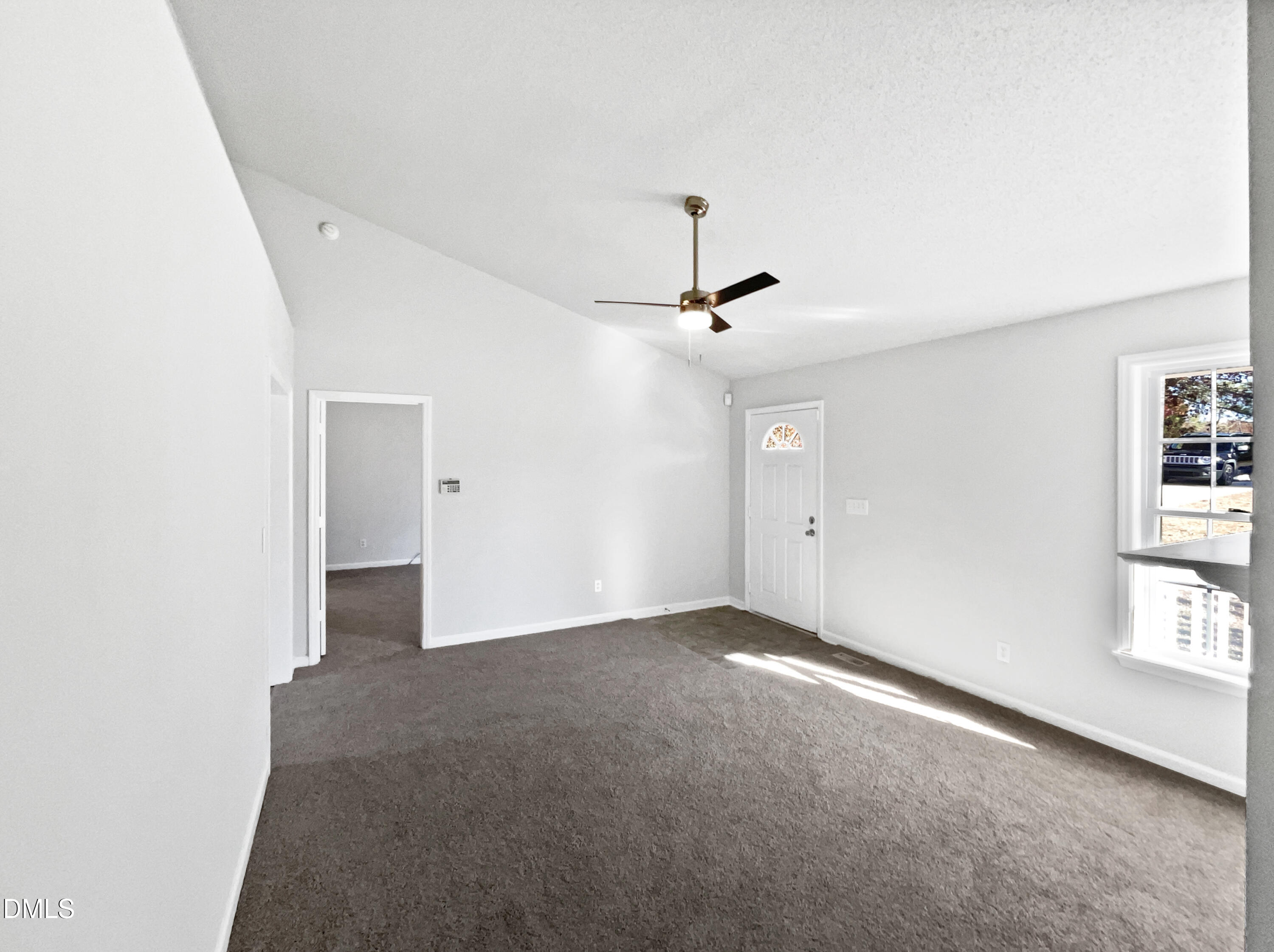 9025 Ferrell Road Zebulon, NC 27597 - Photo 4 of 19 an empty room with windows and fan