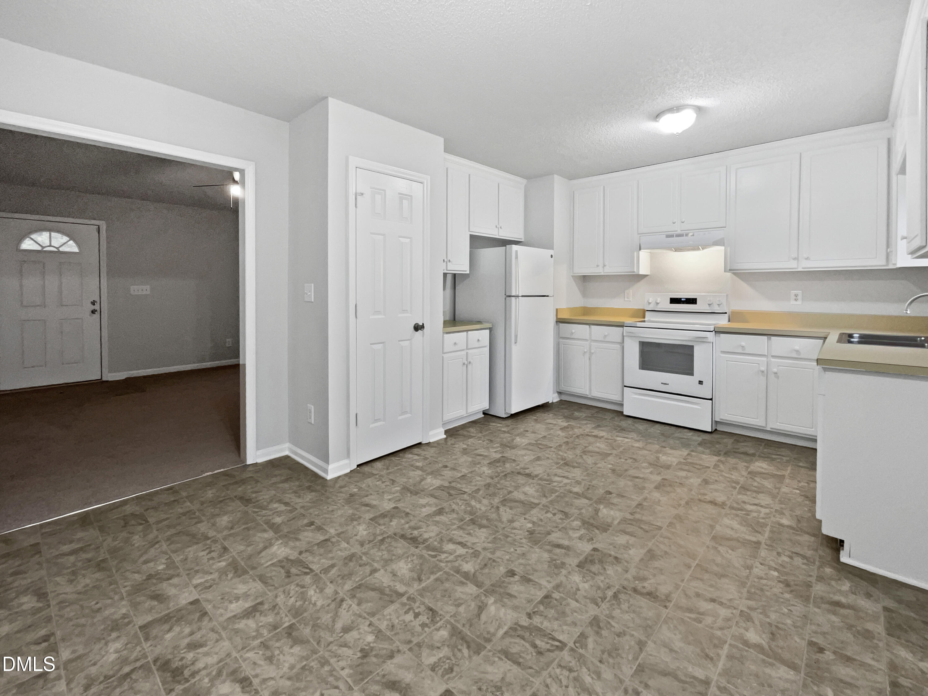 9025 Ferrell Road Zebulon, NC 27597 - Photo 5 of 19 a kitchen with white cabinets and white appliances