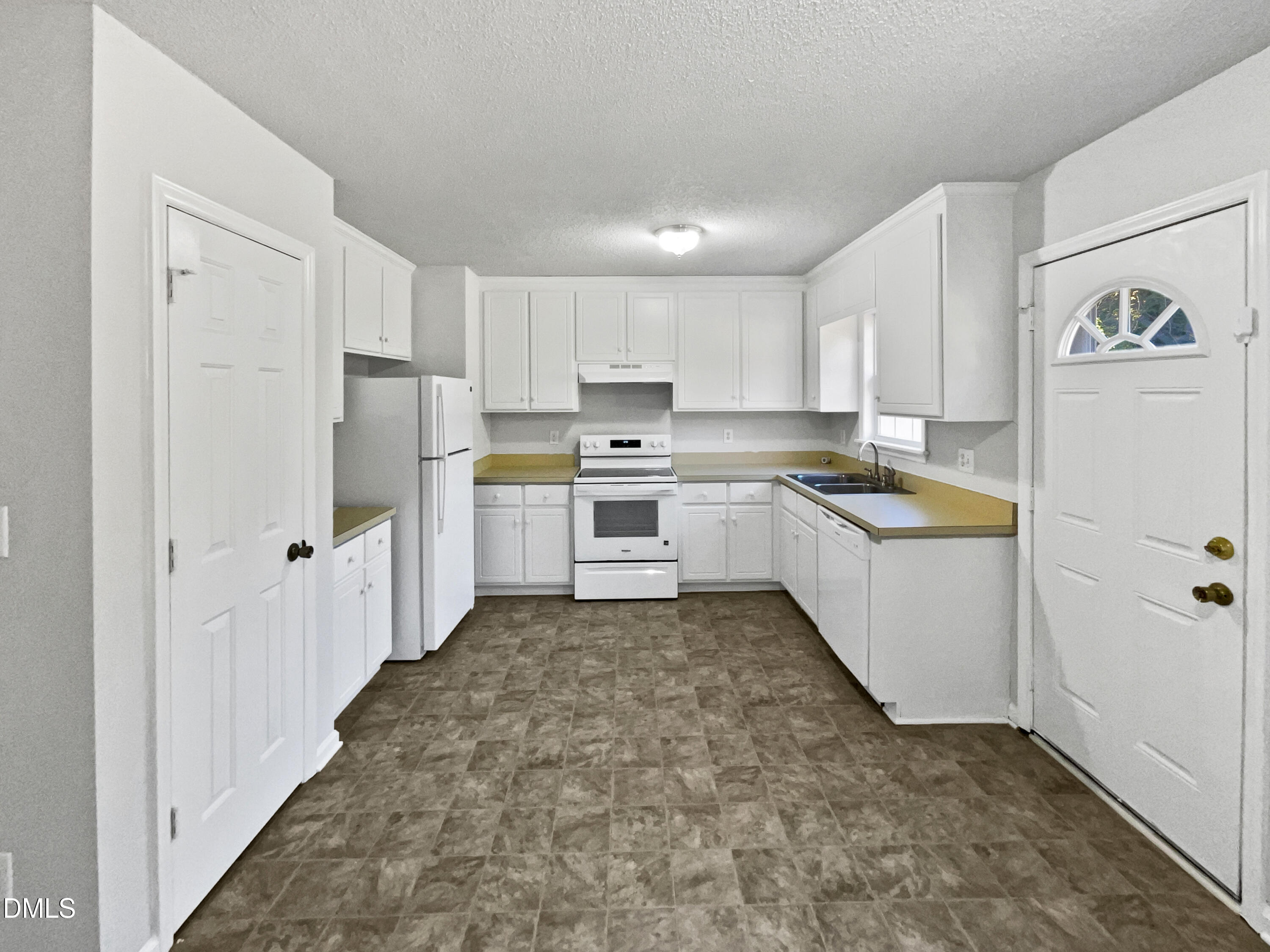 9025 Ferrell Road Zebulon, NC 27597 - Photo 7 of 19 a kitchen with white cabinets and white appliances